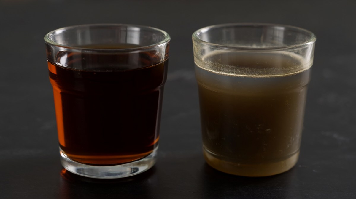 Two glasses of fish sauce side by side, one clear and deep amber, the other cloudy and dull with a film on the surface