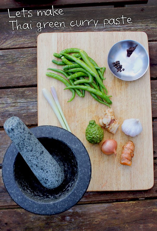 Fresh ingredients for authentic Thai green curry paste arranged on a surface