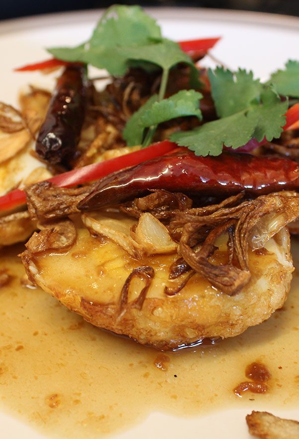 Thai Son-in-Law Eggs served as a side dish with crispy shallots and dried chillies