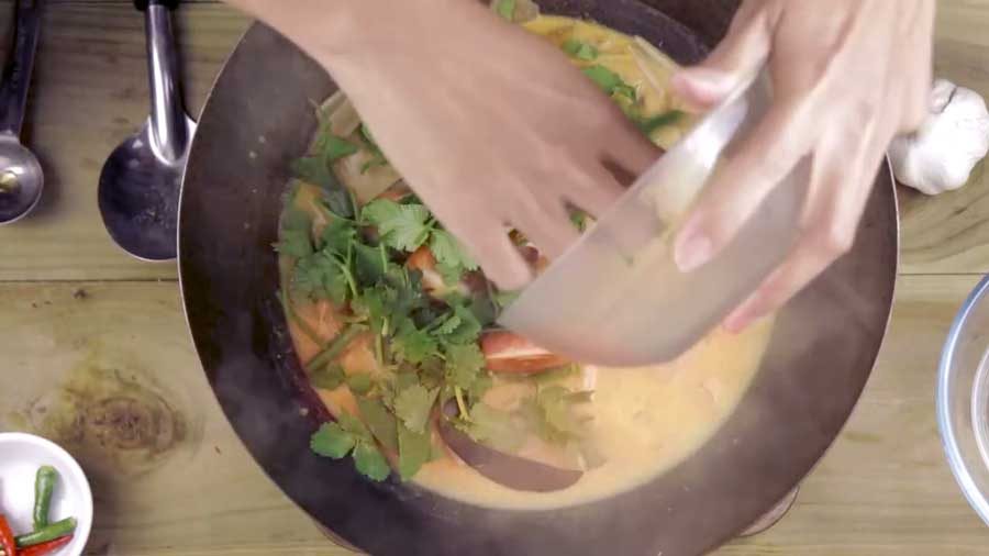 Add the coriander, tomato and spring onions