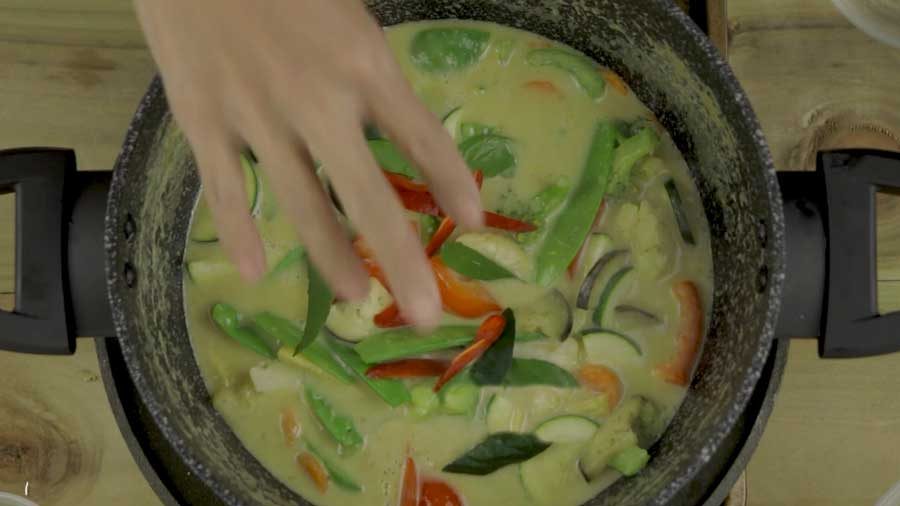 Add the kaffir lime leaves and continue stirring