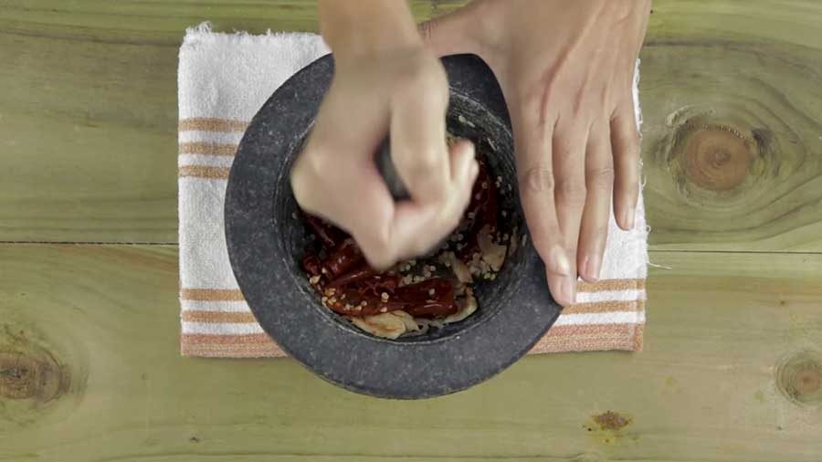 Pound the garlic and chillies together