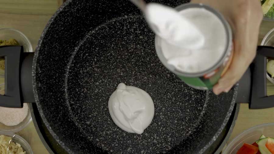 Add a splash of coconut milk to the wok