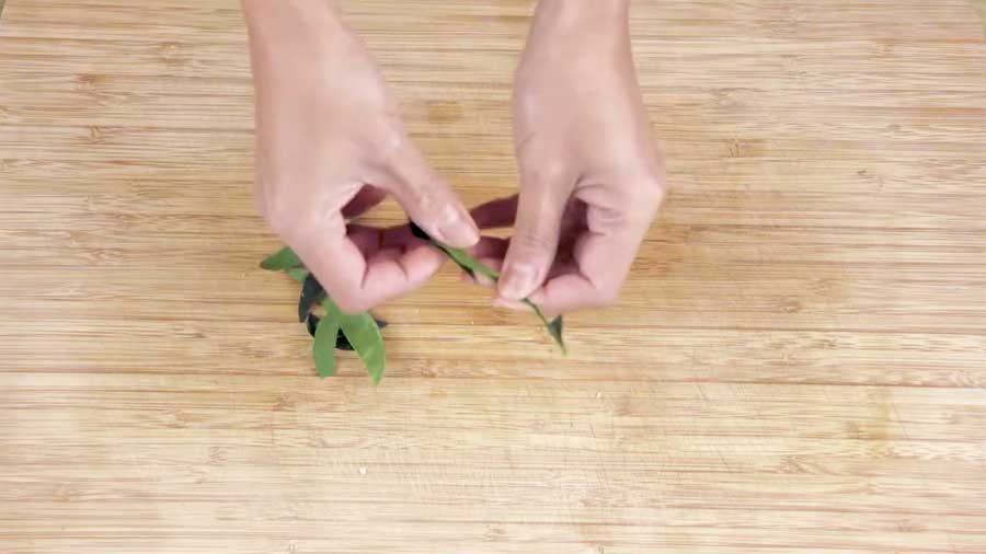 Pull apart the kaffir lime leaves
